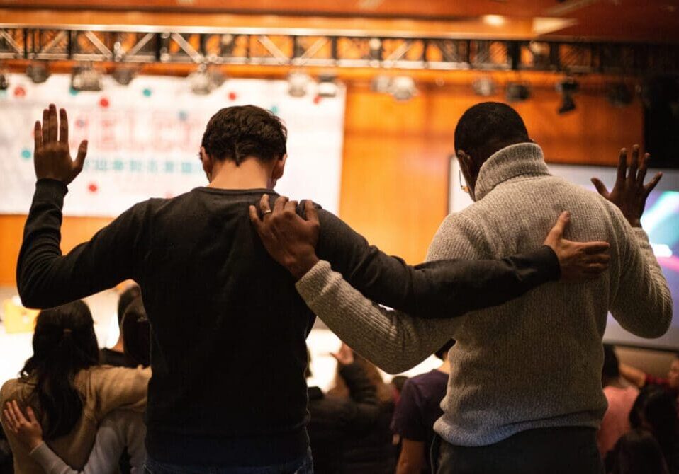 Two people holding hands in a circle.