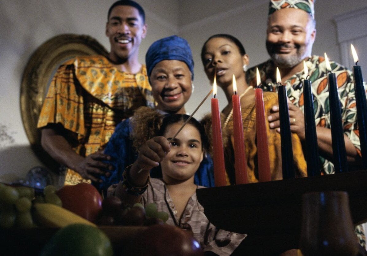 Girl lighting candles to celebrate Kwanzaa